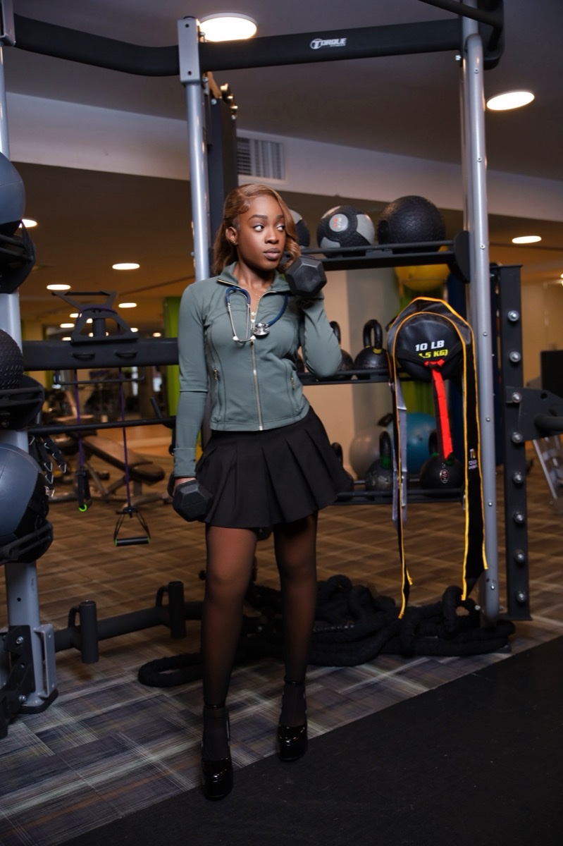 Woman in athletic wear posing in a home gym
